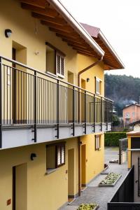 a building with balconies on the side of it at Bilocale Gelsomino - Cascina Da Rosa in Capiago Intimiano
