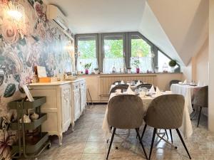 a restaurant with tables and chairs in a room at Szent Kristóf Panzió in Eger +55 photos