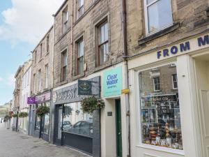a row of shops on a city street at 11A High Street in Jedburgh