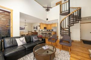 a living room with a black leather couch and a table at Snowblaze Condos Building A unit 33 in Winter Park