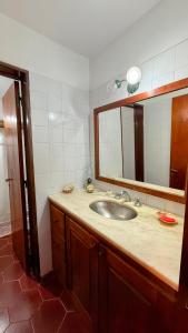 a bathroom with a sink and a mirror at Casa Panoramica Maria Ines in Villa Carlos Paz