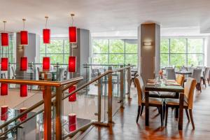 a dining room with red chandeliers and a table at Radisson Blu Hotel, Bristol in Bristol