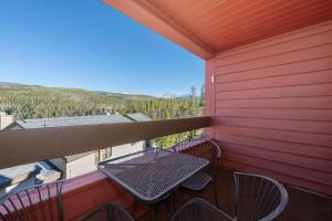 a patio with a table and chairs on a balcony at Snowblaze Condos Building A unit 33 in Winter Park