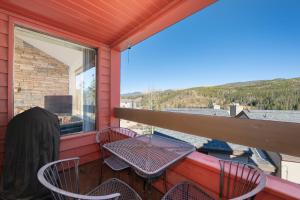 a patio with a table and chairs on a balcony at Snowblaze Condos Building A unit 33 in Winter Park
