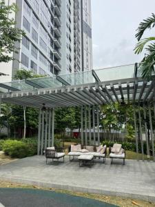 a pavilion with chairs and a glass roof at KLCC Agile Sky villa Residences in Kuala Lumpur