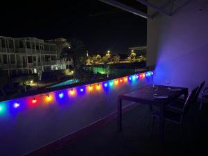 a patio with a table and red and blue lights at Apartamento "Casa el Sargazo" en Vera Playa con Piscina, Solarium, Wifi y Parking Gratis in Vera