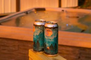 two metal canisters sitting on a table with a bath tub at GVL Retreat with a Hot Tub, Sauna, Firepit and a Gameroom in Taylors