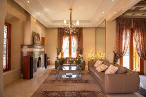 a living room with a couch and a fireplace at Domaine 3 Riads in Marrakech