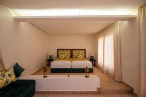 a bedroom with a bed and a couch at Domaine 3 Riads in Marrakech