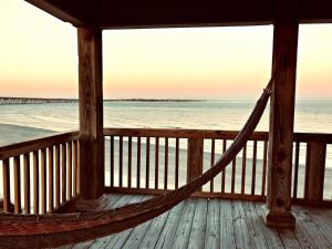 a hammock on a porch overlooking the beach at Atlantis - Oceanfront Seating at its Finest! in Freeport