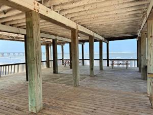 a wooden pier with a view of the beach at Atlantis - Oceanfront Seating at its Finest! in Freeport