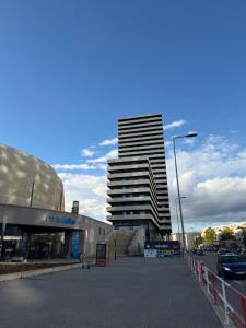 a tall building in the middle of a street at Apartmán na NFŠ Bratislava in Bratislava