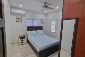 a bedroom with a bed and a ceiling fan at 4Bed Condo - Sleeps 8 - Pool Bbq Views Parking in Philipsburg +22 photos