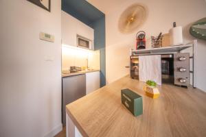 a kitchen with a wooden counter top in a room at Magnifique Studio Illzach Centre in Illzach