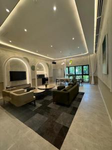 a large living room with couches and a table at KLCC Agile Sky villa Residences in Kuala Lumpur