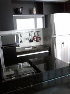 Η κουζίνα ή μικρή κουζίνα στο Flat mobiliado e bem localizado
