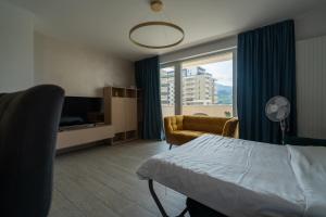 a hotel room with a bed and a window at CH Apartments Urban Plaza in Braşov