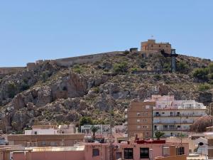 a city with a castle on top of a hill at Casa con Terraza y Parking en el Centro By Aloha Palma in Águilas
