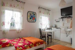 ein Schlafzimmer mit einem Bett und einem Tisch sowie eine Küche in der Unterkunft Tasca im Feui Apartments in Stuttgart