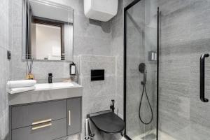 a bathroom with a shower and a sink and a toilet at The Nest Residence by GoodMove - Gauthier Casablanca in Casablanca +70 photos