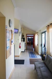 a living room with a couch and a refrigerator at AL Novavista by BPX in Madalena +41 photos