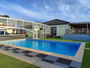 a swimming pool in front of a house at AL Novavista by BPX in Madalena