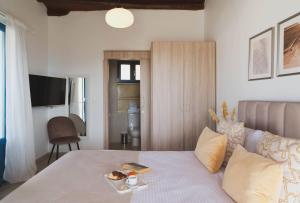 a bedroom with a bed with a tray of food on it at Maisonette at The Olive Manor in Peristerona