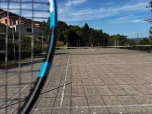 a person playing tennis on a tennis court at Studio à Gérardmer, les Dryades in Gérardmer