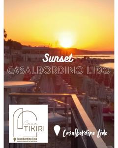 a sunset over a beach with the words sunset casinoexcludingilda life at Casa Tikiri in Casalbordino