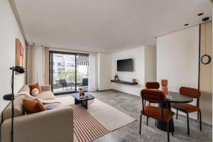 a living room with a couch and a table at The Nest Residence by GoodMove - Gauthier Casablanca in Casablanca