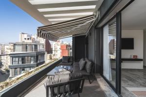 a balcony with a couch and a television on a building at The Nest Residence by GoodMove - Gauthier Casablanca in Casablanca