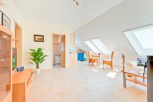 a living room with a table and a dining room at Ferienhaus LampRieger Fewo 1 OG in Wieck
