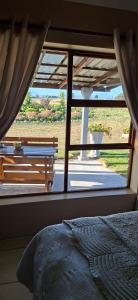 a bedroom with a window looking out at a yard at French Toast in George