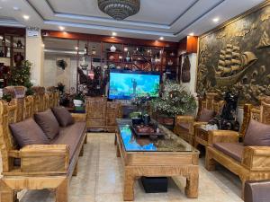 a living room with couches and a flat screen tv at Son Ha Sapa Hotel Plus in Sapa