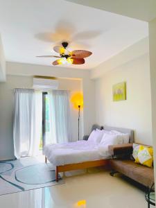 a bedroom with a bed and a ceiling fan at Angsana Breeze-Alpine Crosswinds Tagaytay in Ulot