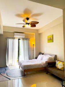 a bedroom with a bed and a ceiling fan at Angsana Breeze-Alpine Crosswinds Tagaytay in Ulot