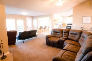 a living room with a couch and a television at Lozano Lake House in Buncome