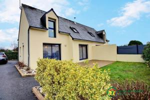 a white house with a black roof at Du golfe in Crach