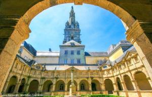 a large building with a tower on top of it at Du golfe in Crach