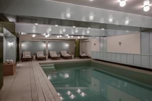 a swimming pool with chairs and a table in a building at Experimental Chalet Val d'Isère in Val-d'Isère