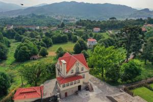an aerial view of a house with a red roof at The Luxury and Nature Retreat with pool, jacuzzi & BBQ in Vila Fonche +77 photos