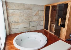 a bathroom with a large tub in a room at The Luxury and Nature Retreat with pool, jacuzzi & BBQ in Vila Fonche