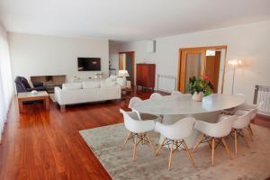 a living room with a white table and chairs at The Luxury and Nature Retreat with pool, jacuzzi & BBQ in Vila Fonche