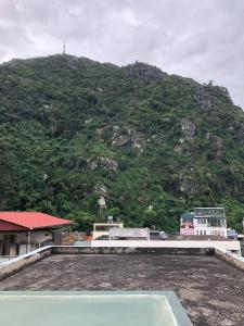 a view of a hill with a mountain in the background at Poem Hostel in Ha Long