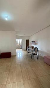 a living room with a table and chairs and a couch at Hospedaria Dona Alice in Lençóis +28 photos
