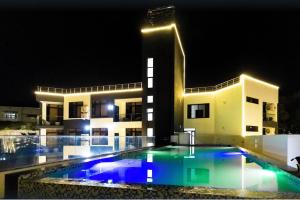 a large building with a swimming pool at night at Cascadia Hotel Apartments by GF Greenland in Kigali