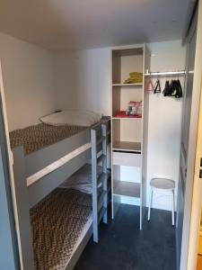 a room with two bunk beds and a chair at Villa Pinede du Golf PORT LEUCATE in Port Leucate