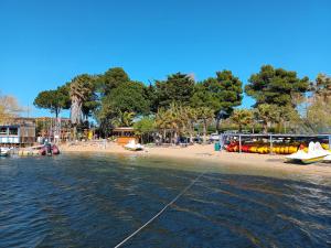 a beach with a boat in the water at Villa Pinede du Golf PORT LEUCATE in Port Leucate