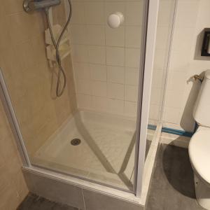 a shower with a glass door in a bathroom at Villa Pinede du Golf PORT LEUCATE in Port Leucate