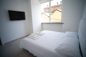 una camera da letto bianca con un letto e una finestra di 13 Nevoso Palace a Milano